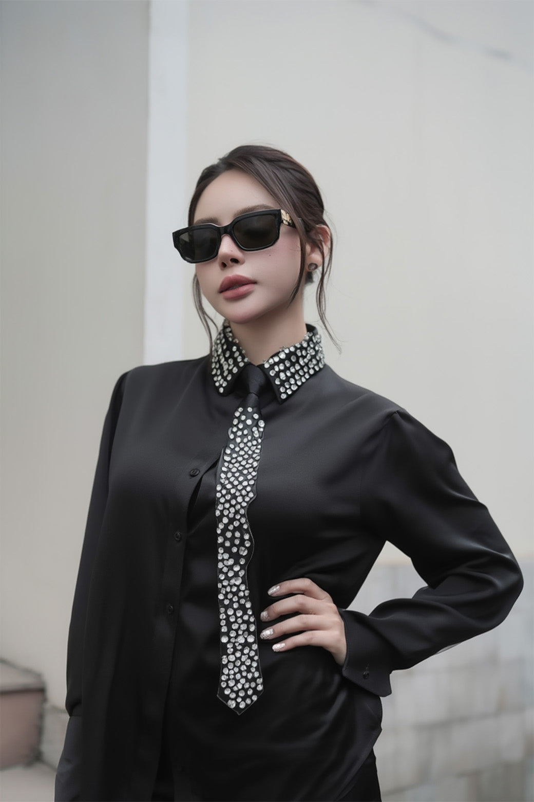 Person wearing a black outfit with a decorative collar, Gentle Monster Soho 01, and a neutral background.