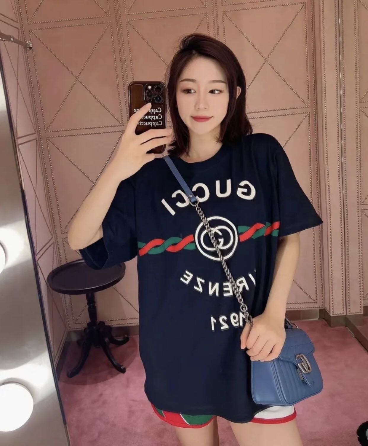 Women wearing a Gucci Cotton Jersey Gucci Firenze 1921 T-shirt in Navy 616036 XJD7T 4795 with a mirror reflection.