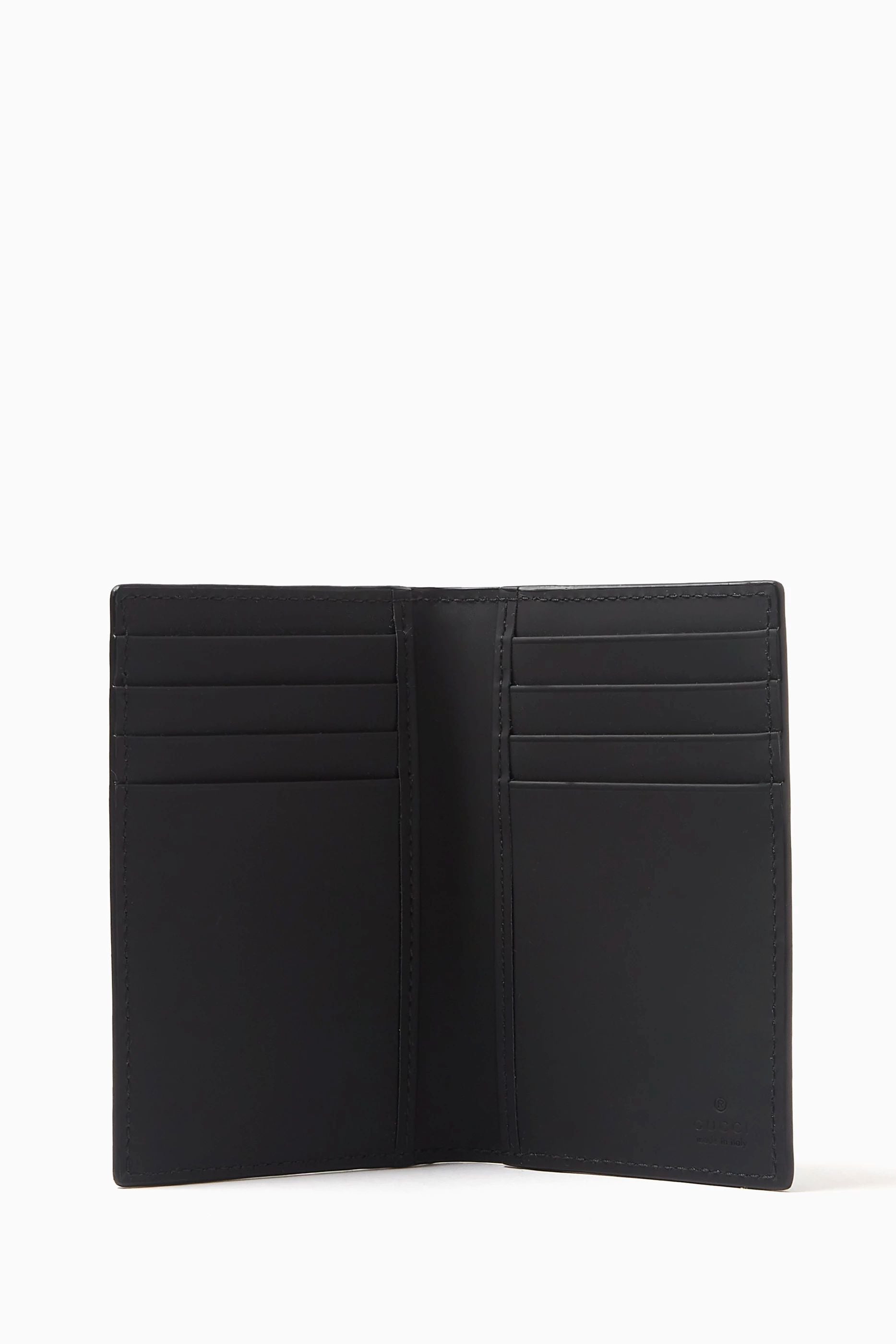 Gucci GG Black Rubber-Effect Long Card Case 771317 AAC0L 1000 - A black leather bi-fold wallet shown open, displaying multiple card slots on both sides, set against a plain white background. 
