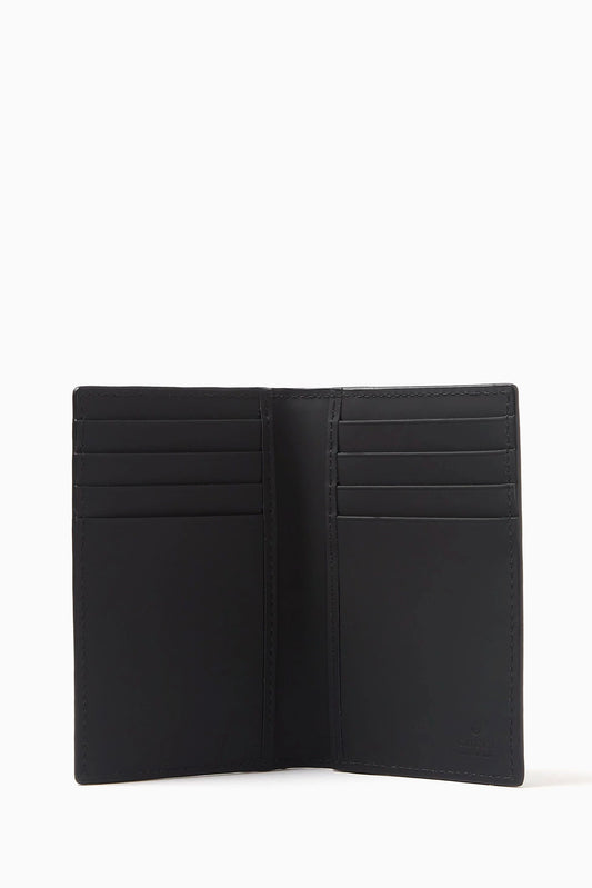 Gucci GG Black Rubber-Effect Long Card Case 771317 AAC0L 1000 - A black leather bi-fold wallet shown open, displaying multiple card slots on both sides, set against a plain white background. 
