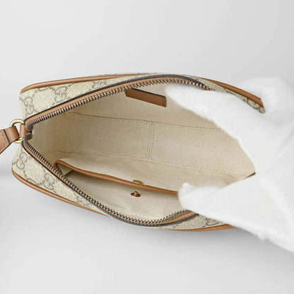 Open Gucci GG Embossed Super Mini Cognac Beige Shoulder Bag 821216 FAED3 9786 with a patterned strap on a white background