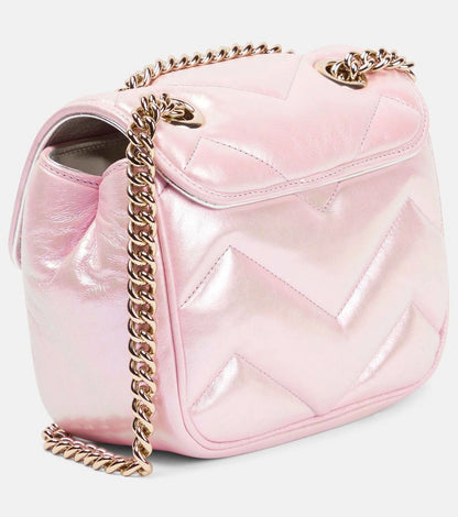 Behind Gucci GG Marmont Iridescent Mini Crossbody Bag in Pink 739682 AAC2U 5826 with a gold chain strap on a white background
