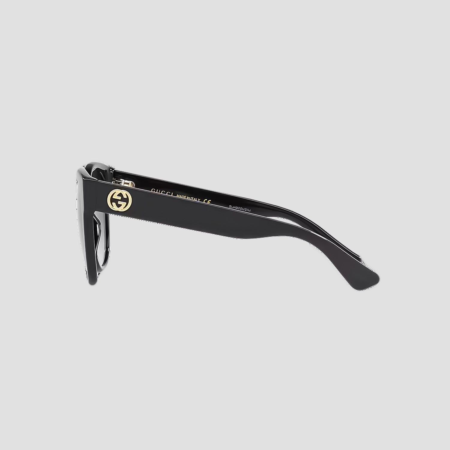 Gucci GG0035SN-001 Round Sunglasses with a gold logo on a light gray background