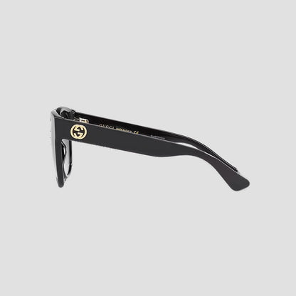 Gucci GG0035SN-001 Round Sunglasses with a gold logo on a light gray background