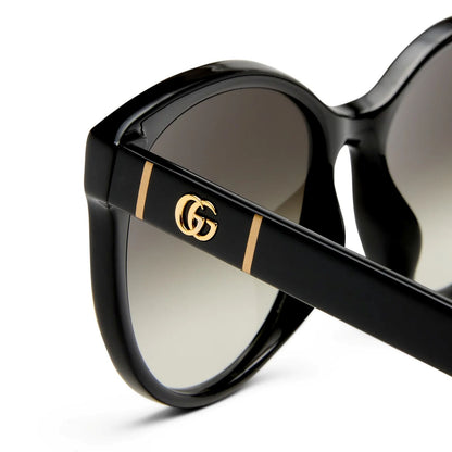 Gucci GG0636SK 001 Black Round Sunglasses with a gold logo on a white background