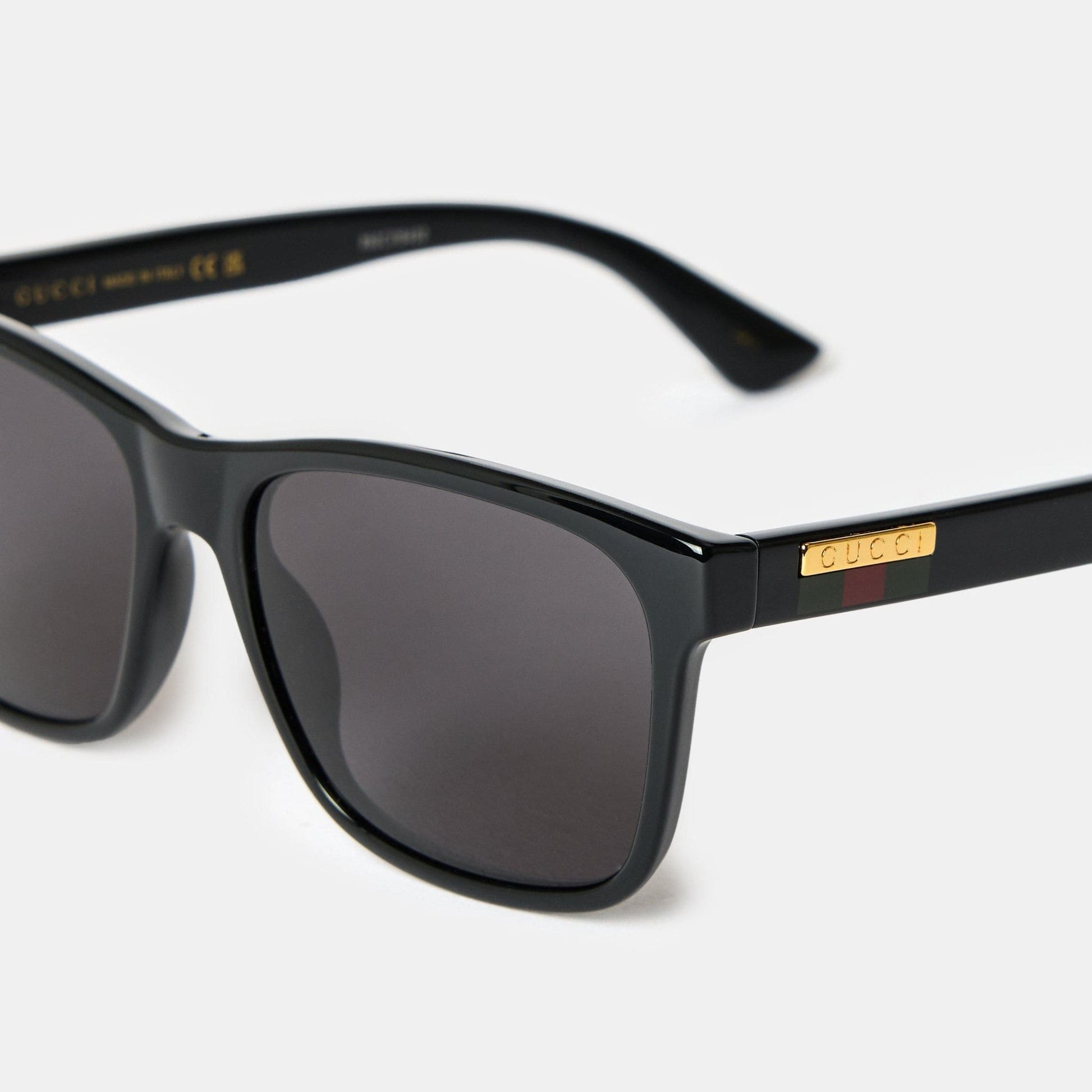 Gucci GG0746S Black Square Sunglasses with gold accents on a white background