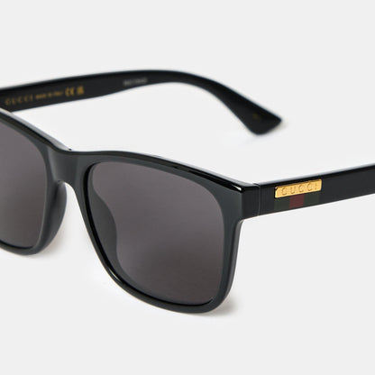 Gucci GG0746S Black Square Sunglasses with gold accents on a white background