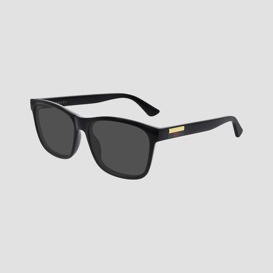 Gucci GG0746S Black Square Sunglasses with dark lenses and a small gold metal accent on the temple, shown on a plain white background.