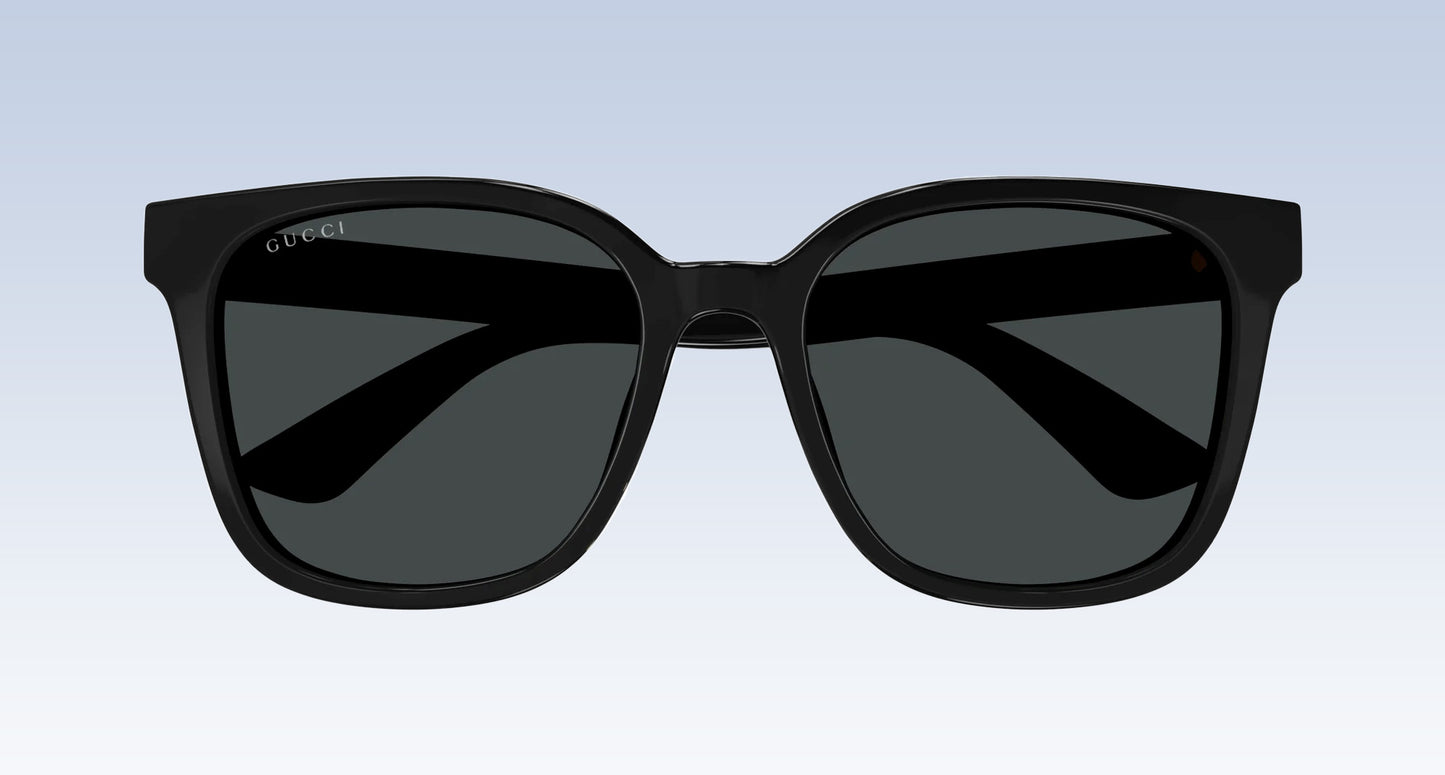 Gucci GG1346SK 001 Black Square Oversize Sunglasses with a glossy black frame and dark gray lenses, shown from the front against a light blue gradient background.