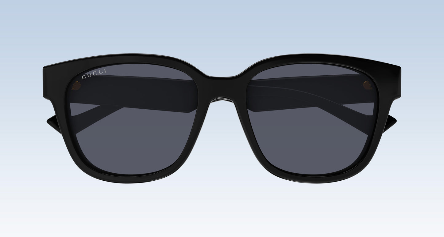 Gucci GG1430SK 001 Black Squared Sunglasses with a thick black frame and dark gray lenses, shown from the front against a light blue gradient background.