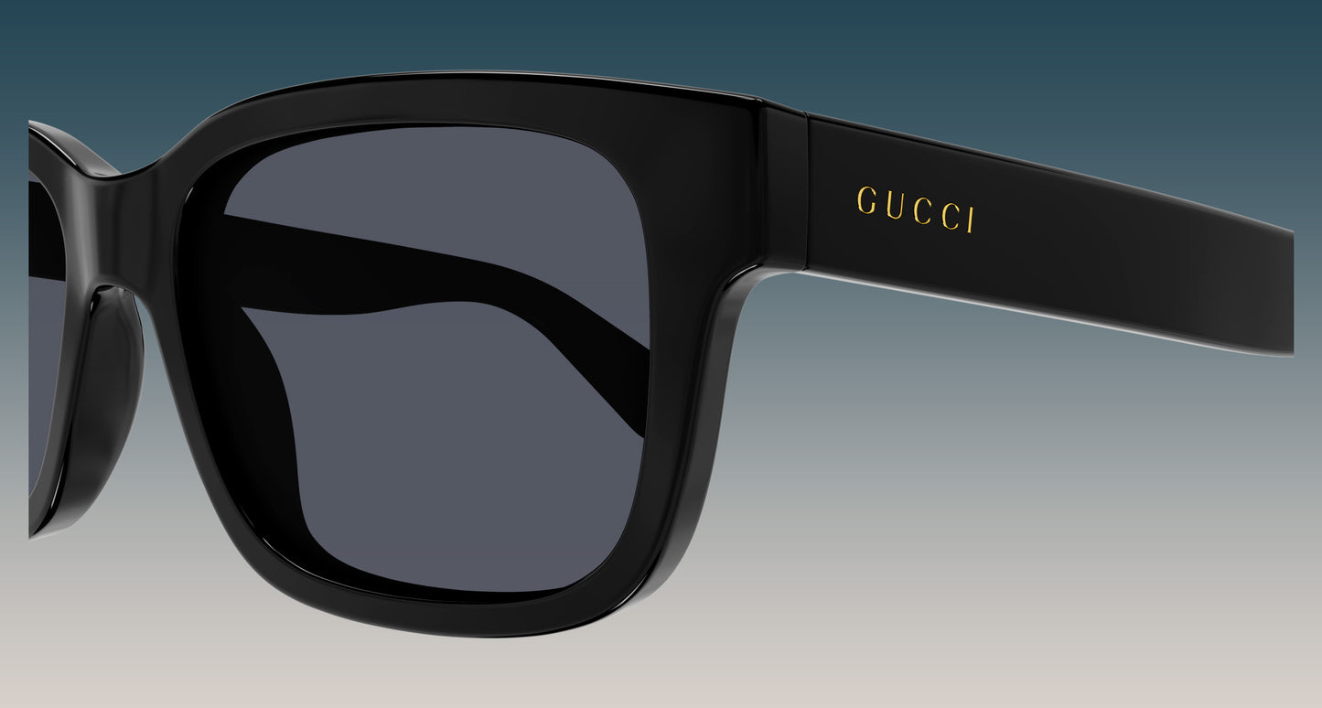 Gucci GG1583S 001 Black Squared Sunglasses with a glossy black frame and dark gray lenses, featuring the gold 'GUCCI' logo on the temple arm, set against a blue-to-gray gradient background.