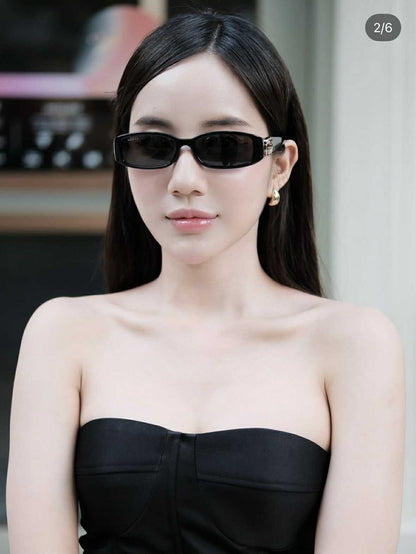 Woman wearing Gucci GG1661S 001 Sunglasses and a strapless black dress indoors.