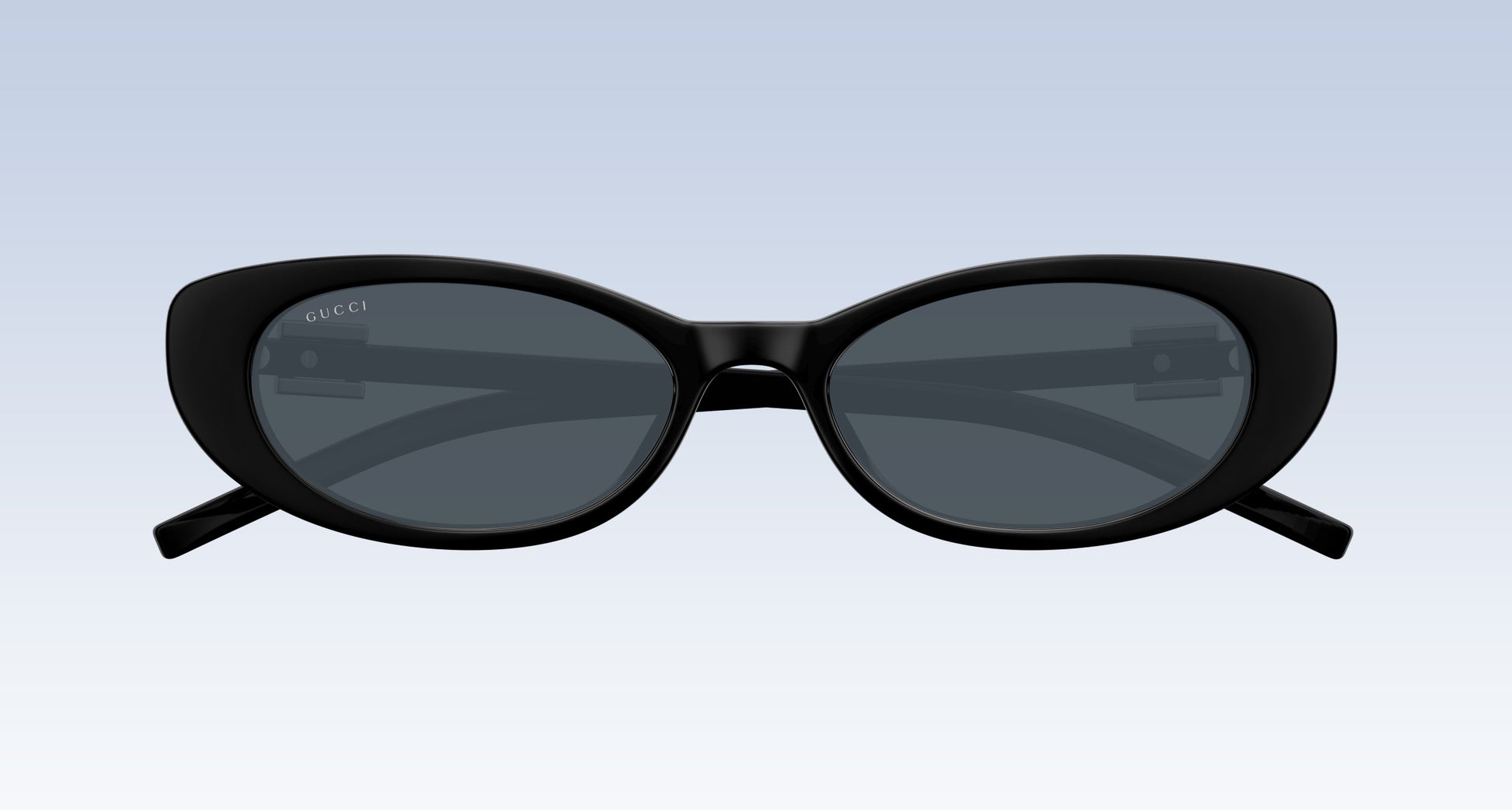 Gucci GG1680S 002 Black Oval Sunglasses with a glossy black frame and dark gray lenses, shown from the front on a light blue gradient background.