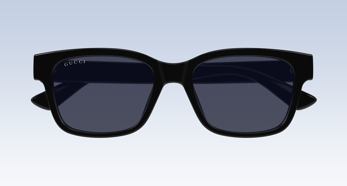 Gucci GG1716S Black Square Sunglasses with a thick black frame and dark tinted lenses, shown from the front on a light blue gradient background.