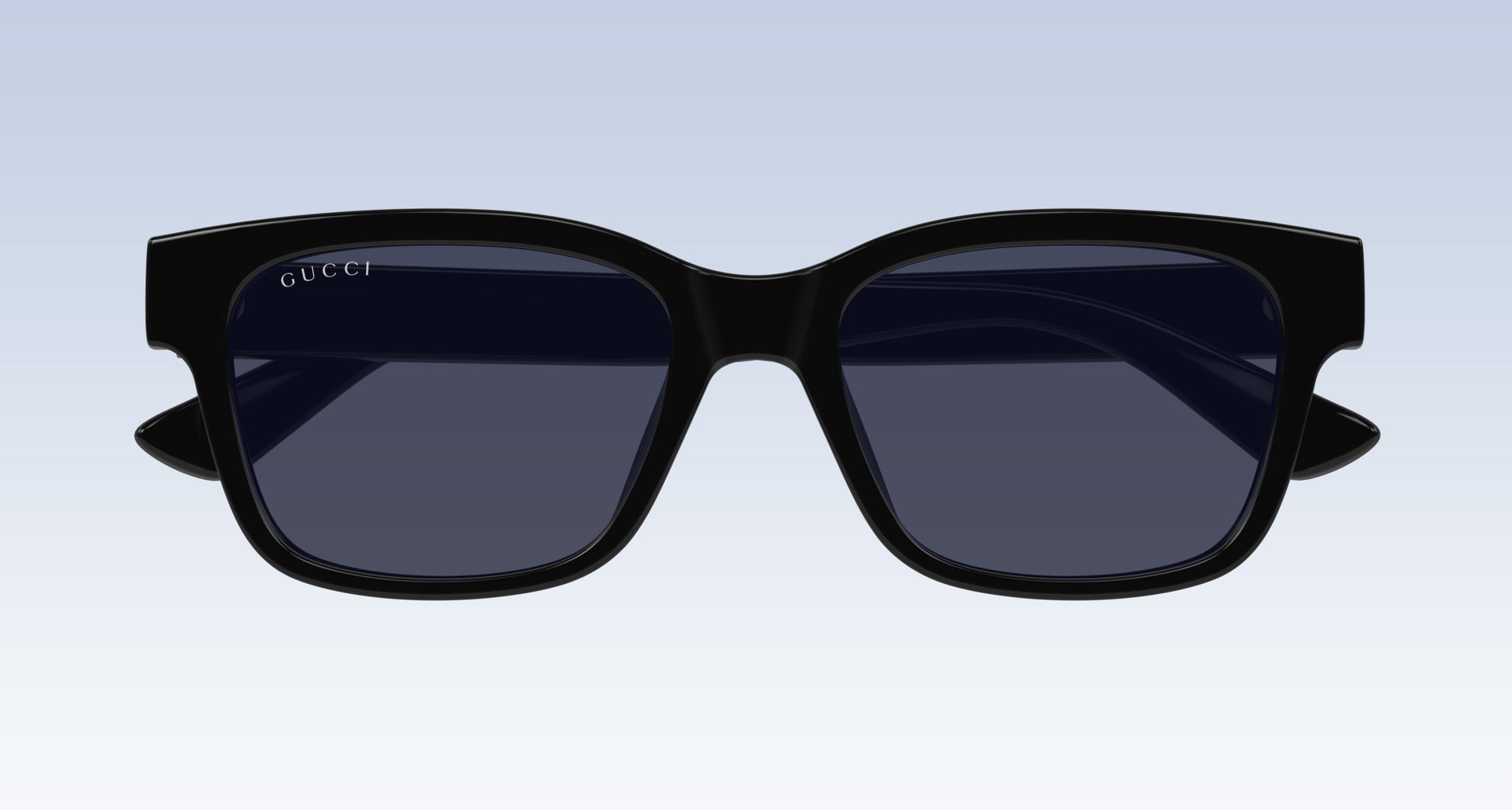 Gucci GG1716S Black Square Sunglasses with a thick black frame and dark tinted lenses, shown from the front on a light blue gradient background.