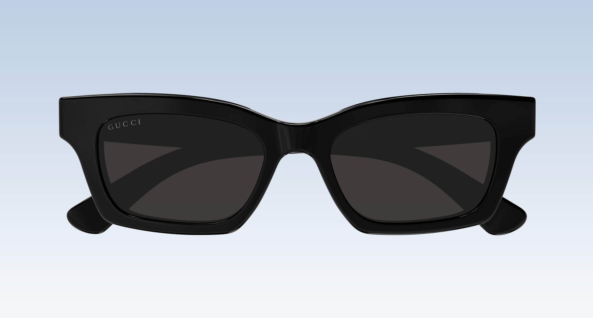 Gucci GG1790S 001 Black Rectangular Sunglasses with a glossy black frame and dark tinted lenses, shown from the front against a light blue gradient background.