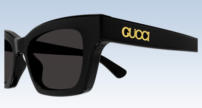 close-up Gucci GG1790S 001 Black Rectangular Sunglasses with the letter "Gucci" gold metal finished