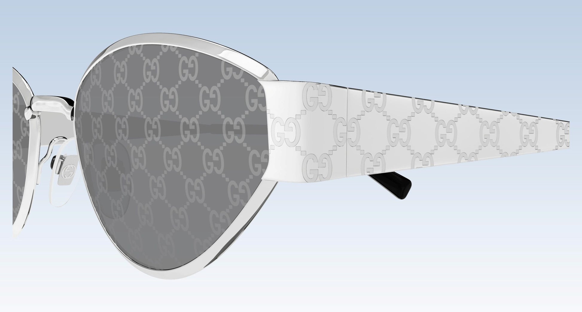 Gucci GG1853S 002 Silver Butterfly Sunglasses with a silver-tone metal frame and gray tinted lenses, shown in a side profile view against a light blue gradient background.