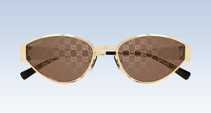 Gucci GG1853S 003 GG double-G patterned brown sunglasses with gold-tone metal frames and black temple tips, shown against a light blue gradient background.