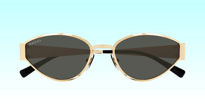 Gucci GG1853S 001 Gold Butterfly Sunglasses with a gold-tone metal frame and dark gray lenses, shown against a light blue gradient background.