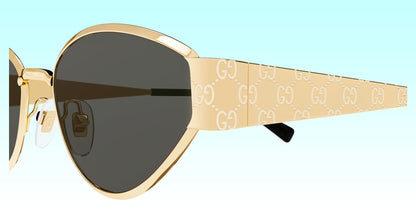 Close-up side view of Gucci GG1853S 001 Gold Butterfly Sunglasses with a gold-tone frame, dark lenses, and a beige temple featuring the repeating Gucci GG monogram.