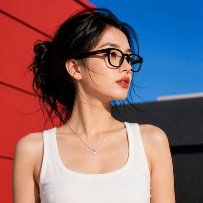 A woman wearing Gucci GG1859O-001 Black Square Eyeglasses, a white ribbed tank top, and a silver necklace, set against a vibrant background of red and blue.