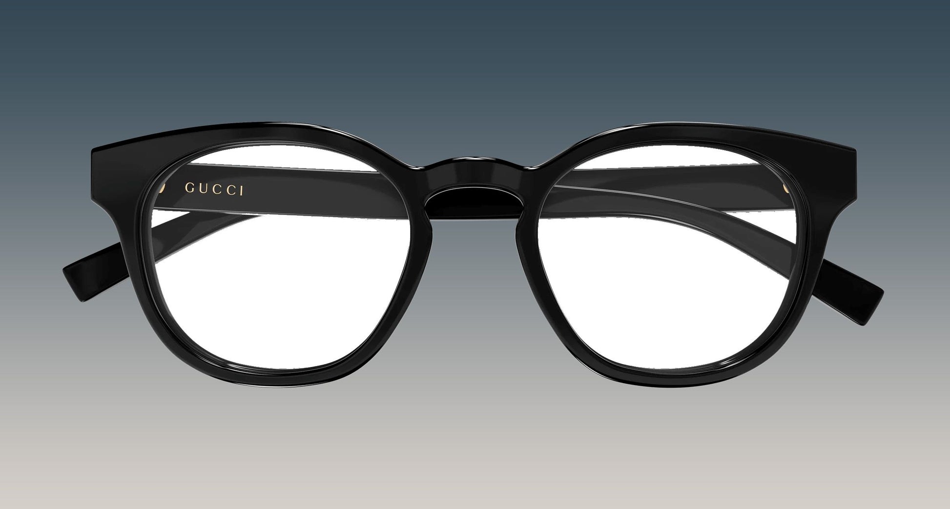 Gucci GG1859O-001 Black Square Eyeglasses frames with a thick, rounded square shape and gold logo lettering on the inner left frame, shown against a gradient gray background.