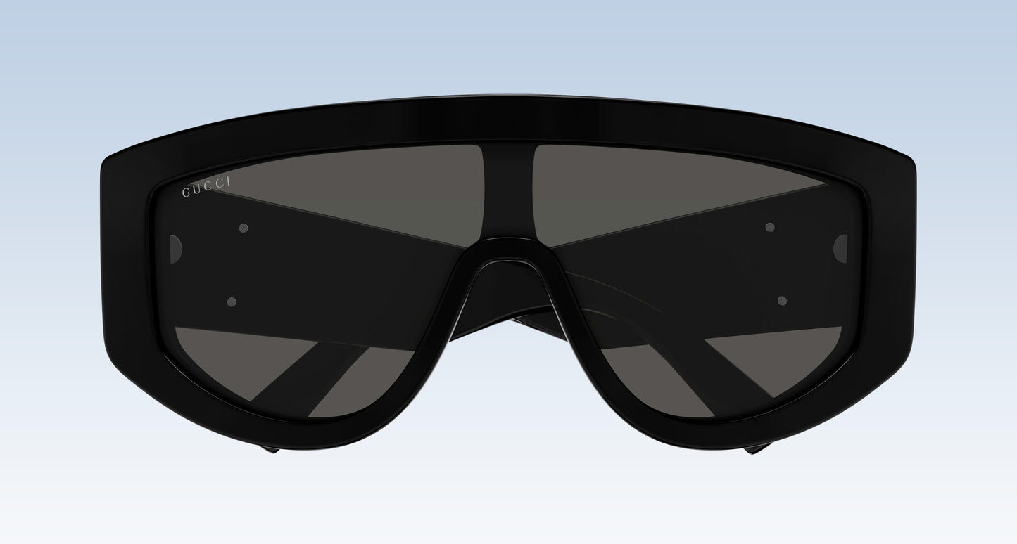 Gucci GG1950S 001 Black Shield Sunglasses with a thick black frame and dark tinted lenses, shown against a light blue gradient background.