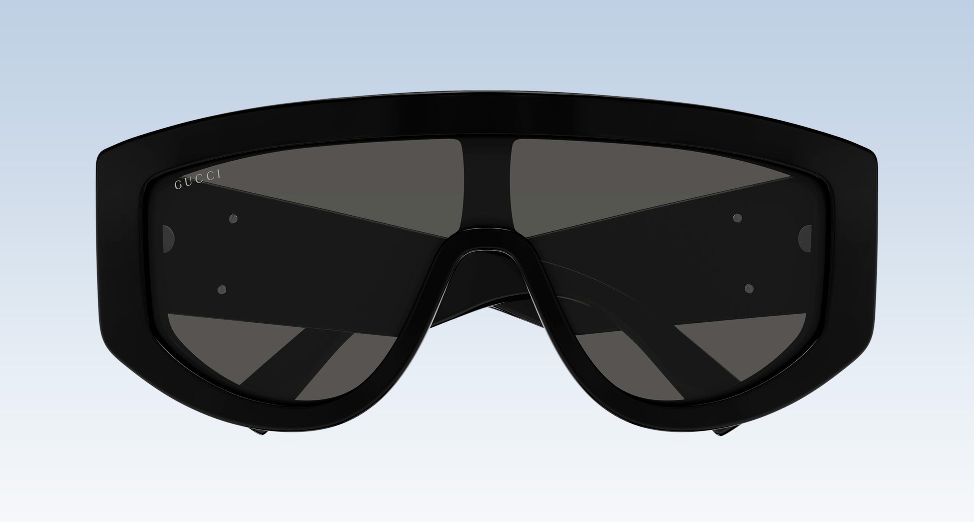 Gucci GG1950S 001 Black Shield Sunglasses with a thick black frame and dark tinted lenses, shown against a light blue gradient background.