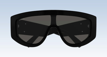 Gucci GG1950S 001 Black Shield Sunglasses with a thick black frame and dark tinted lenses, shown against a light blue gradient background.