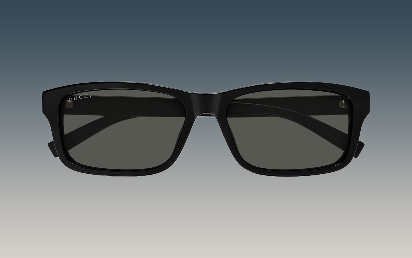 Gucci GG1986SA 001 Black Rectangular Sunglasses with a thick black frame and dark gray lenses, shown against a gradient gray background.