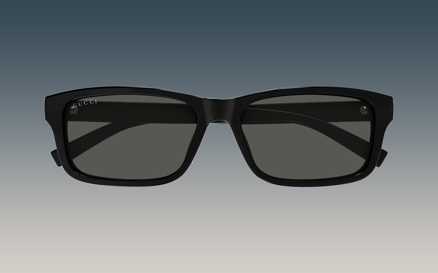 Gucci GG1986SA 001 Black Rectangular Sunglasses with a thick black frame and dark gray lenses, shown against a gradient gray background.