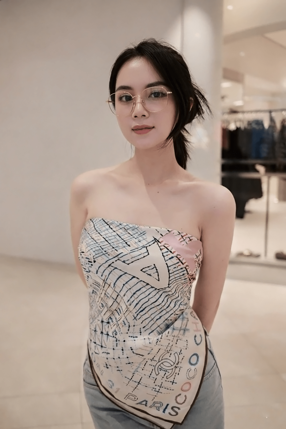 Woman wearing a Gucci GG2006OA 001 Eyeglasses & strapless dress with a pattern in an indoor setting