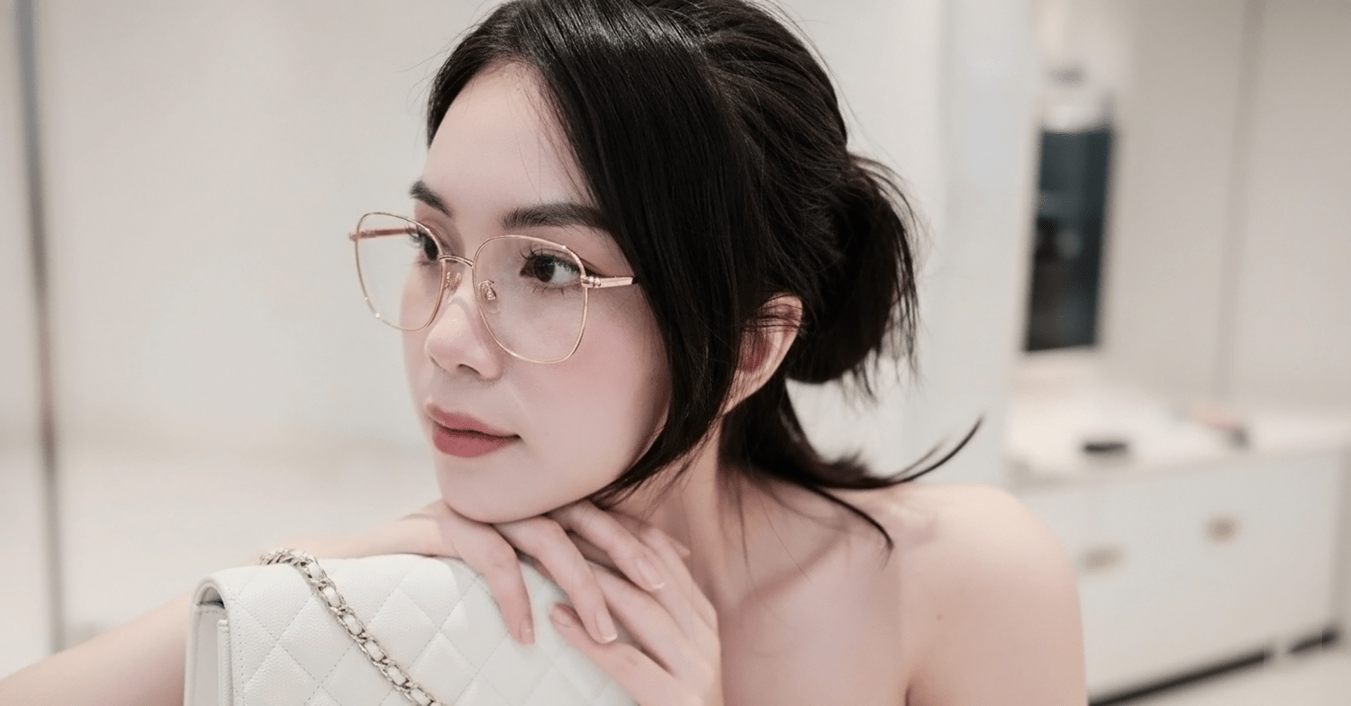 Woman wearing Gucci GG2006OA 001 Eyeglasses and a white handbag indoors