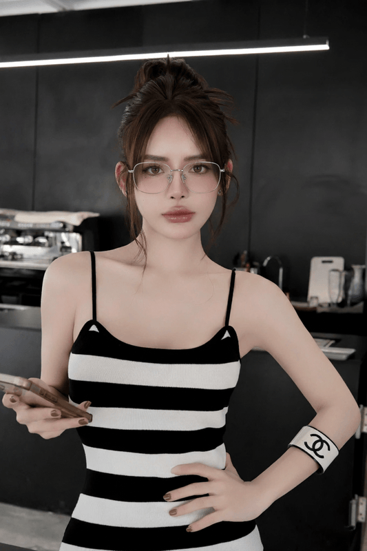 Woman wearing Gucci GG2006OA 002 Silver Eyeglasses, a black and white striped tank top in a kitchen setting