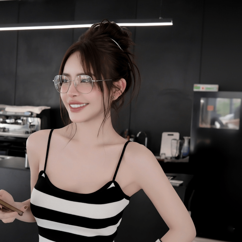 Woman wearing Gucci GG2006OA 002 Silver Eyeglasses with a black and white striped top in a kitchen setting