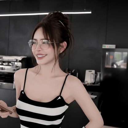 Woman wearing Gucci GG2006OA 002 Silver Eyeglasses with a black and white striped top in a kitchen setting