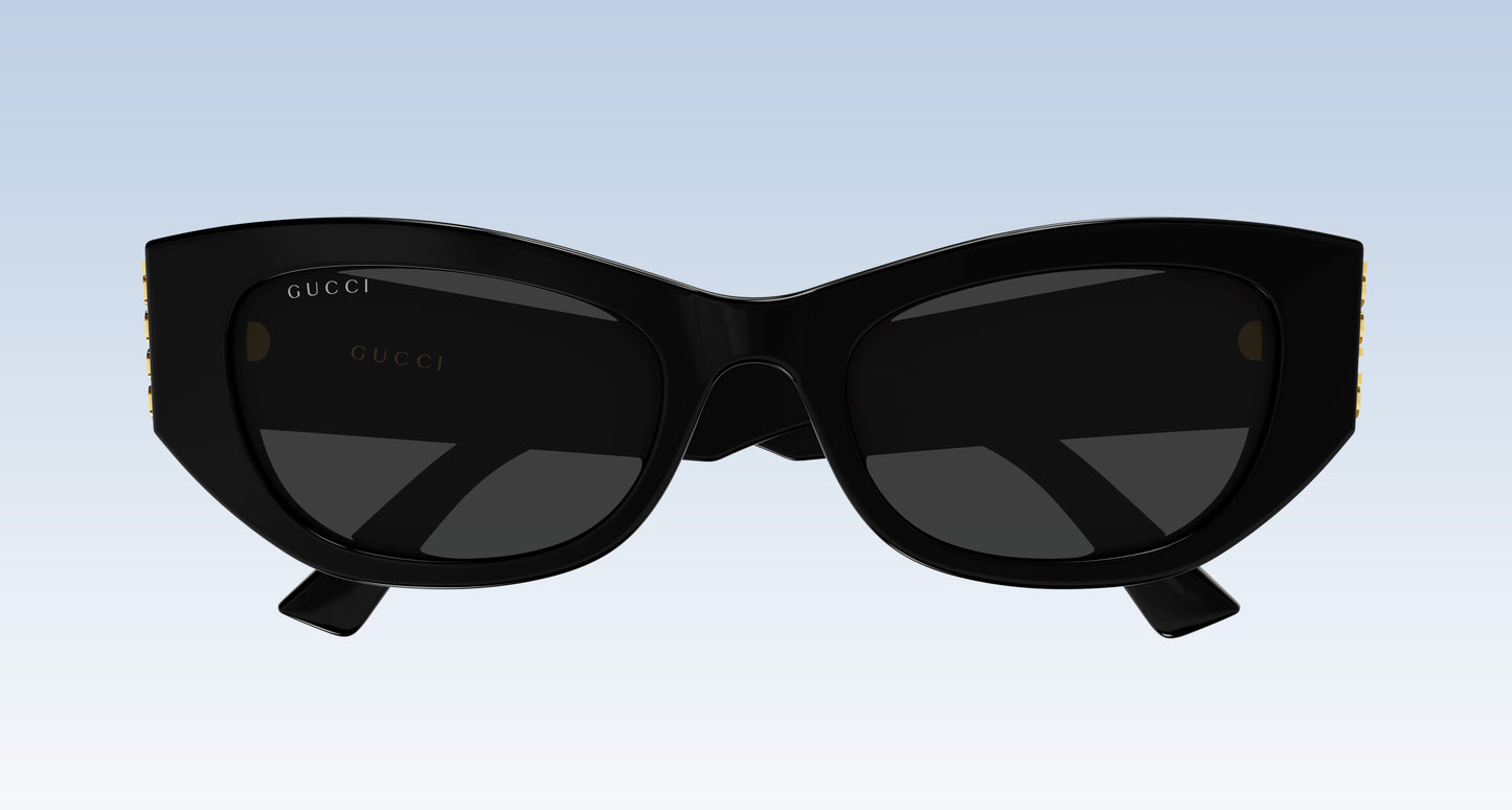 Gucci GG2044SA-001 Black Soft Rectangular Sunglasses with a glossy black frame and dark lenses, shown against a light blue gradient background.