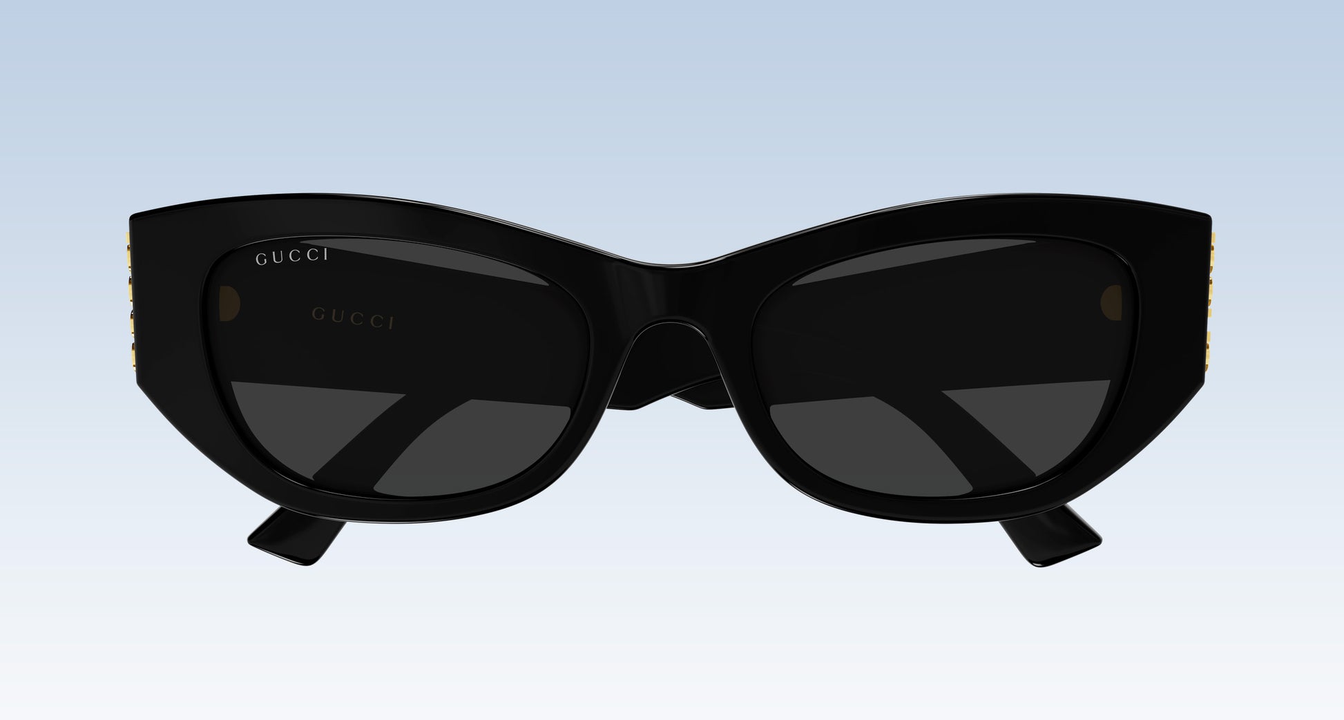 Gucci GG2044SA-001 Black Soft Rectangular Sunglasses with a glossy black frame and dark lenses, shown against a light blue gradient background.