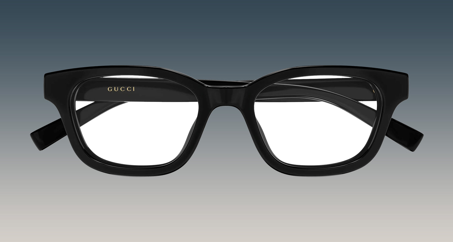 Gucci GG2103OL-001 Black Rectangular Eyeglasses with a thick, rounded rectangular frame and gold logo lettering on the inner left frame, shown against a gradient gray background.