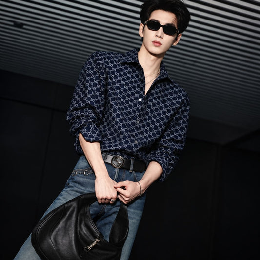 Man wearing Gucci GG2152S 001 Black Rectangular Sunglasses in Gucci monogram navy-shirt, holding black jackie bag