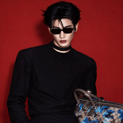 Man wearing Gucci GG2152S 001 Black Rectangular Sunglasses holding Gucci Boston monogram bag