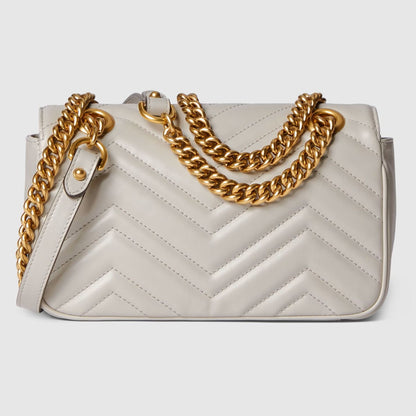 Behind Gucci GG Marmont Small Shoulder Bag Light Grey 446744 AABZC 1712 with gold chain strap on a light gray background