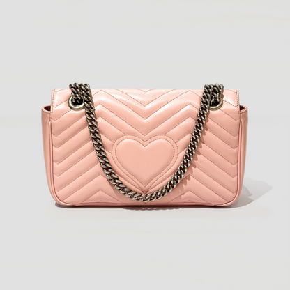 GUCCI MEDIUM MARMONT MATELASSÉ PINK SHOULDER BAG 443497 DTDIY 5815 with a heart design and chain strap on a light gray background