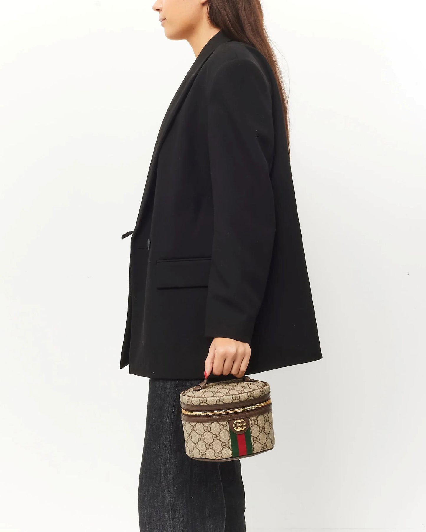 Person holding a Gucci Mini Ophidia Cosmetic Case 627463-96IWG-8745 against a white background