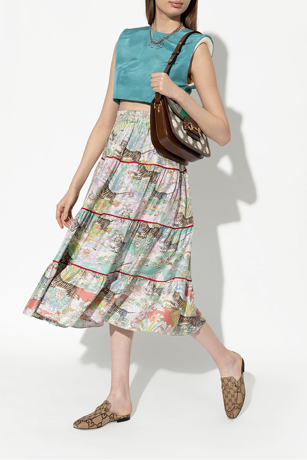 women wearing Gucci Women Princetown Slippers Jumbo Beige 475094 UKO60 2588 holding gucci bag and wearing Gucci tiger skirt