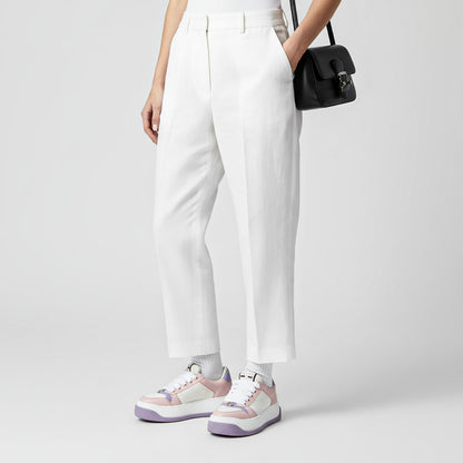 Person wearing white pants and Gucci Women Screener Pink Lilac Sneakers 813080 FADZQ 9161 on a plain background