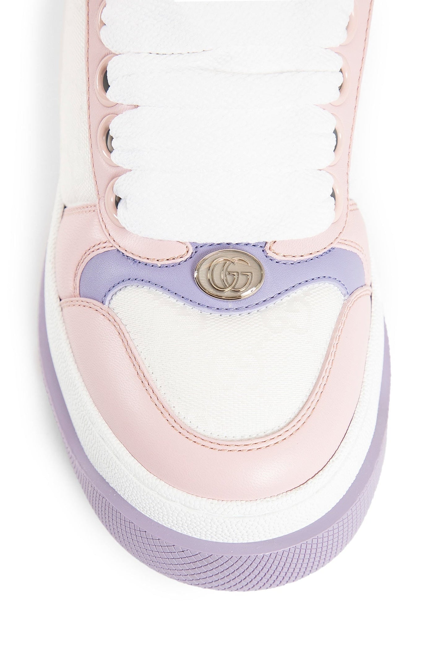 Close-up of a pink and purple sneaker with a brand logo on a white background