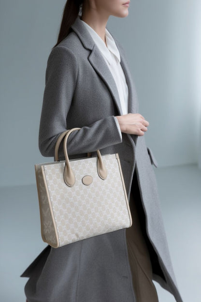Person holding a Gucci Small Tote Bag With Interlocking G Beige 659983 UULBT 9683 with a blurred background