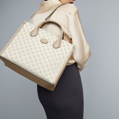Person wearing a Gucci Small Tote Bag With Interlocking G Beige 659983 UULBT 9683 against a gray background